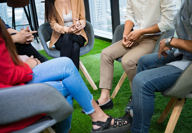 A circle of people in a classroom discussion